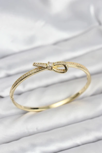Pirinç Gold Renk Zirkon Taşlı Fiyonk Model Kadın Kelepçe Bileklik ürün görseli 1
